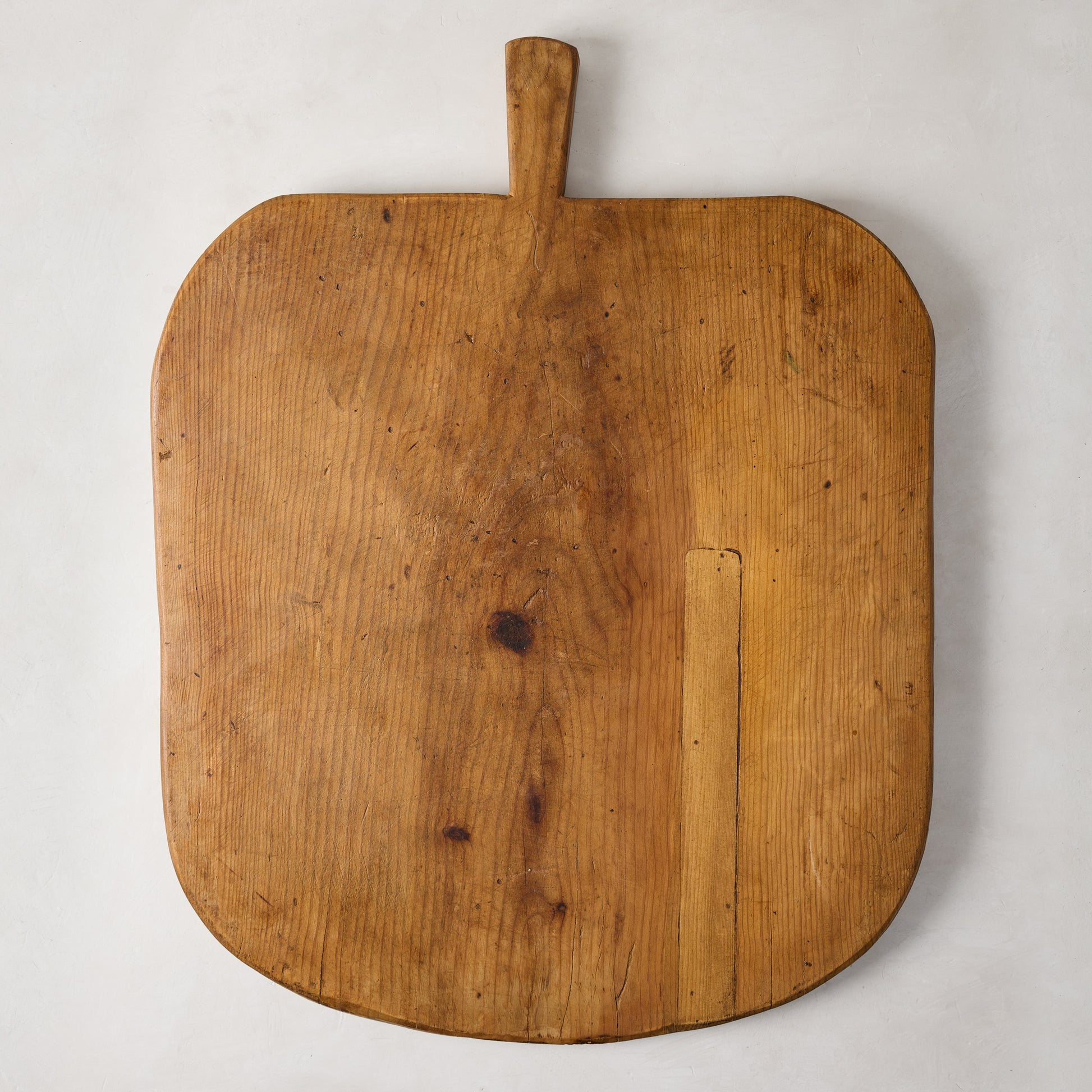 Large vintage reclaimed wood serving board with handle, natural grain, knots, and rich patina.