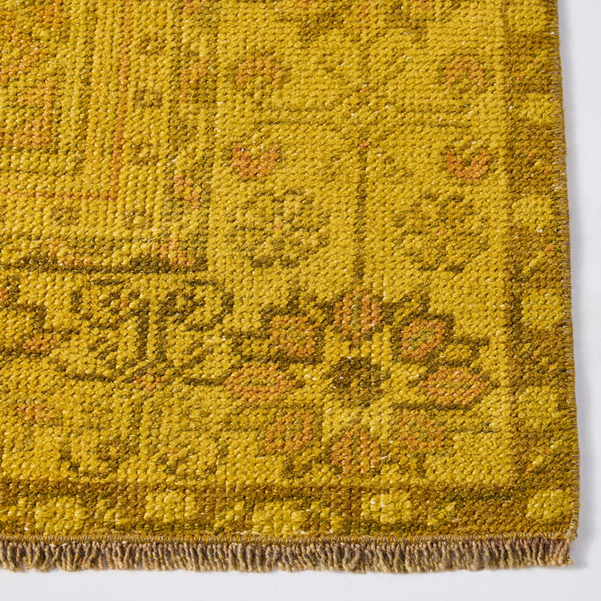 Vintage yellow wool runner rug with faded Aztec-inspired patterns and a low-pile, handcrafted texture.