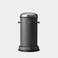 Vipp black 4-gallon pedal bin with stainless steel lid and pedal, and side handles.