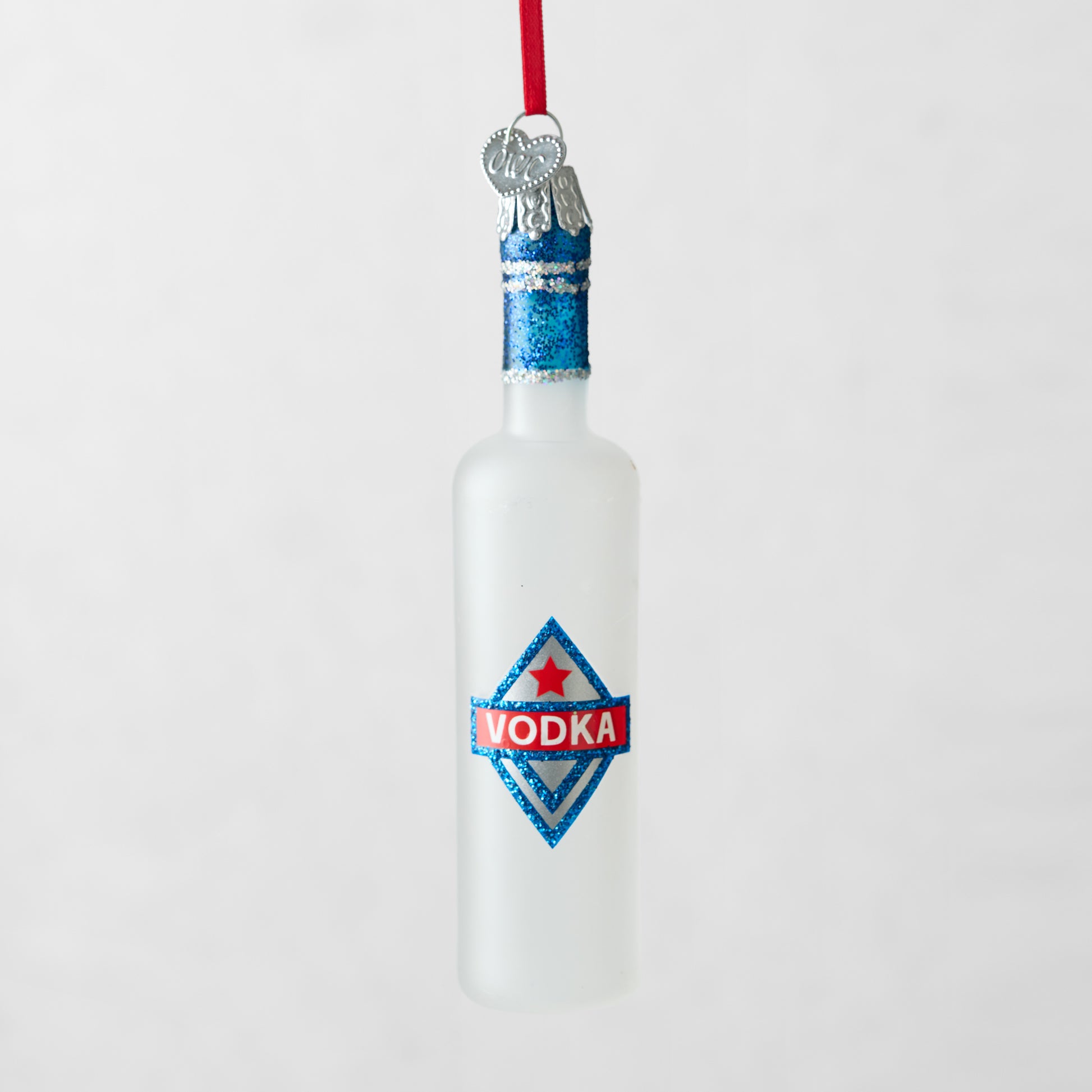 Frosted glass vodka bottle Christmas ornament with blue glitter top and "VODKA" label.