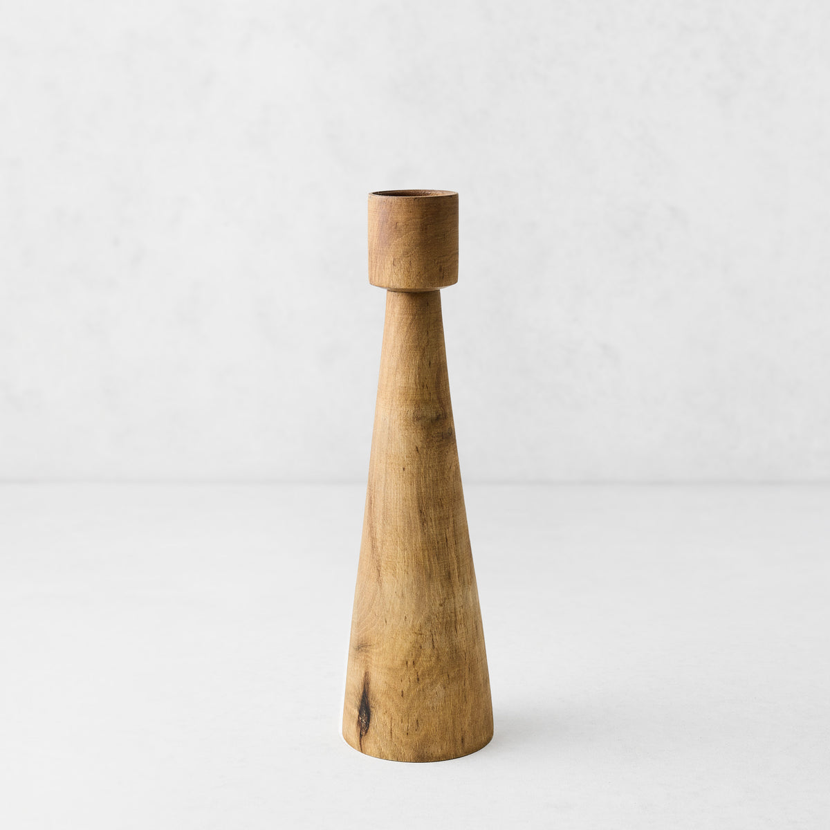 Hand-carved walnut wood candlestick with a tapered geometric design, 12 inches tall, on a white background.