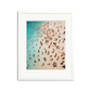 We Forest Framed Wall Art Print: Aerial view of a crowded beach with turquoise water, white sand, and many people, in a white wooden frame with a mat.