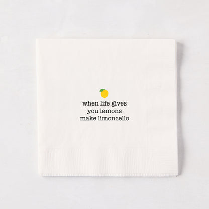 White 5.5" square paper cocktail napkin with "when life gives you lemons make limoncello" text and lemon graphic.