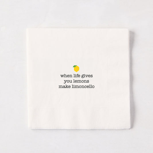 White 5.5" square paper cocktail napkin with "when life gives you lemons make limoncello" text and lemon graphic.