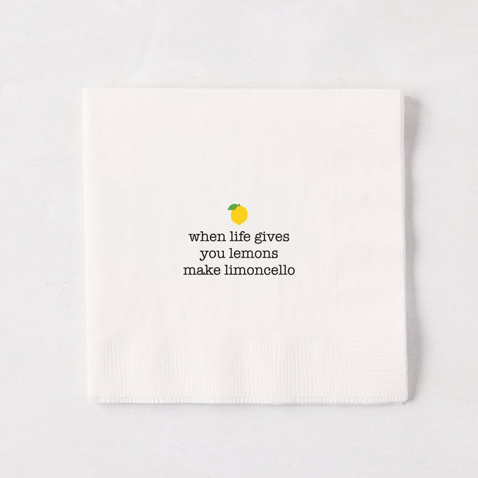 White 5.5" square paper cocktail napkin with "when life gives you lemons make limoncello" text and lemon graphic.