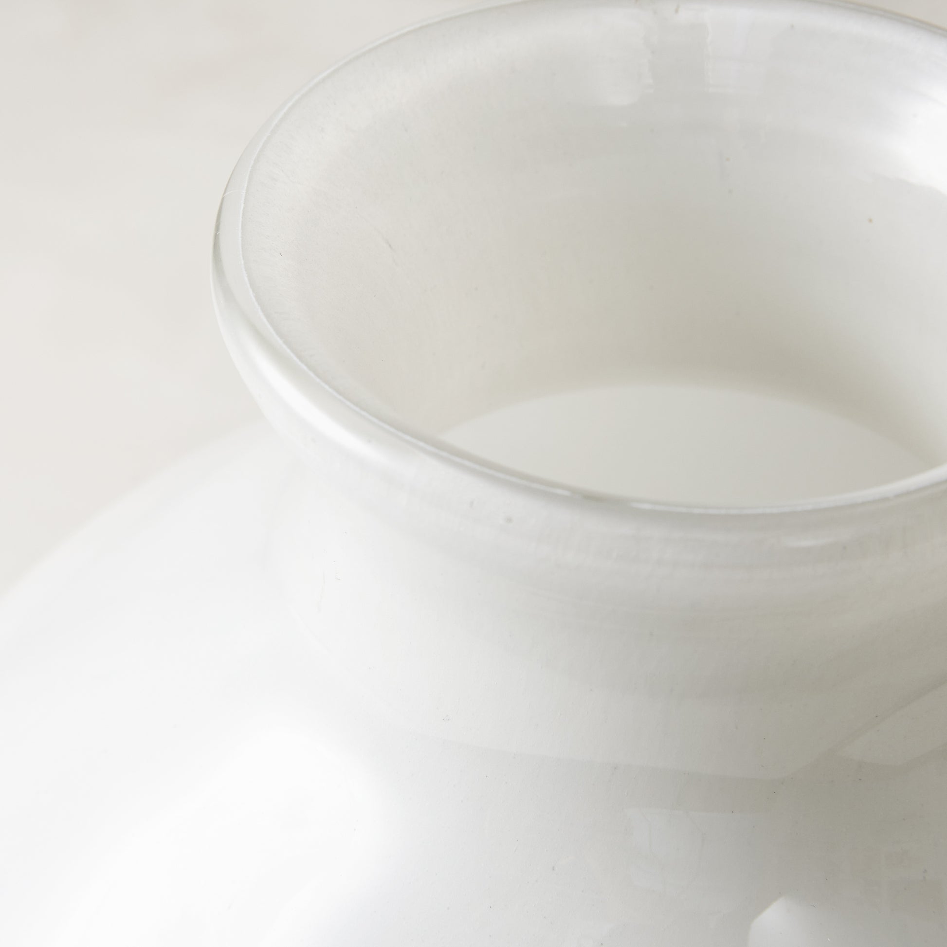 Oversized opaque white handblown glass Bucca vase, 11.4"W x 11.8"H, with a wide rim.