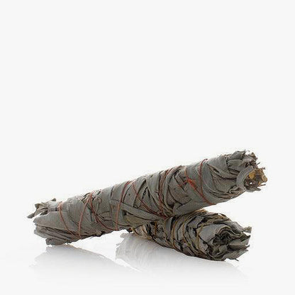 Two white California sage smudge sticks tied with organic hemp string.