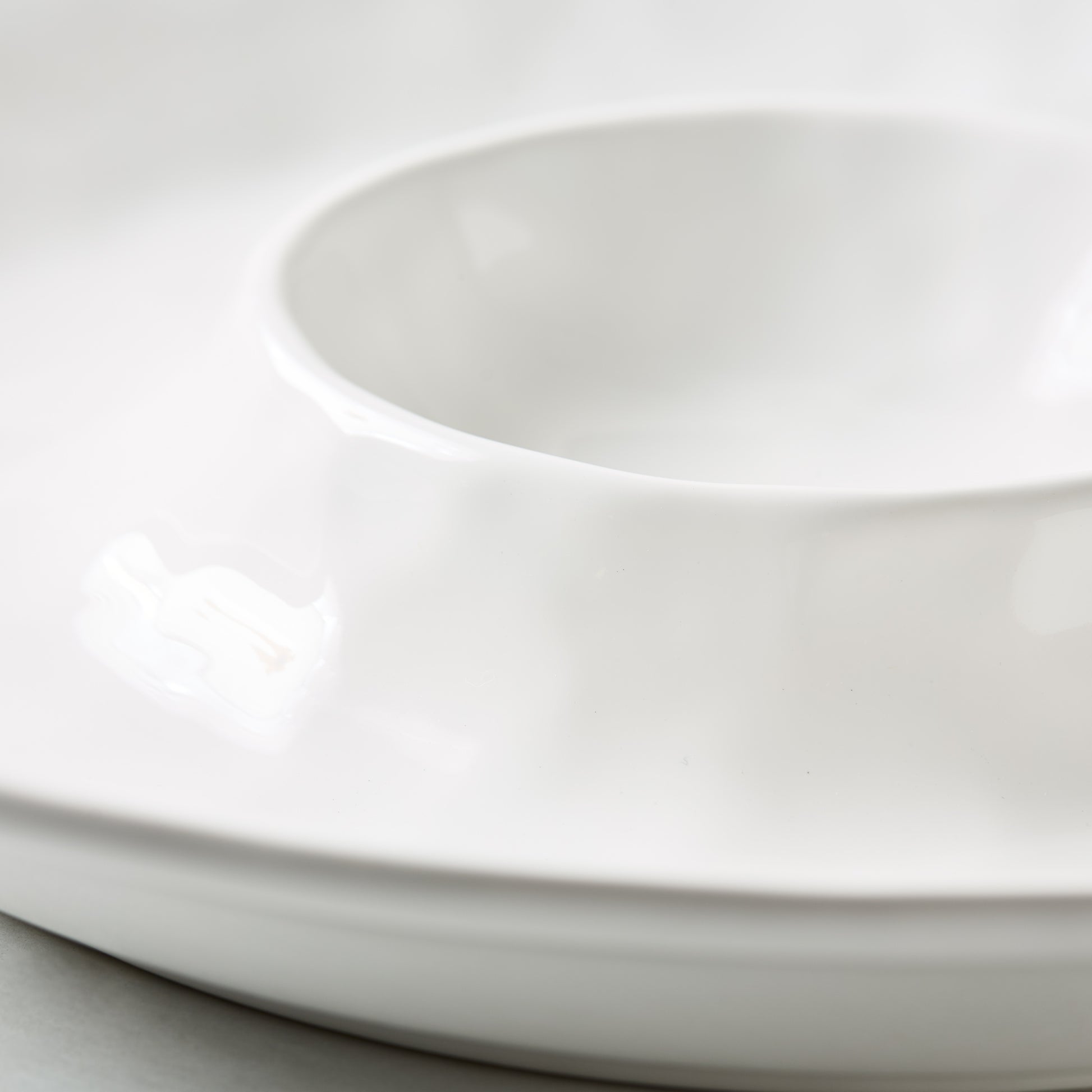 White ceramic 15"Dia chip and dip serving platter with a European-inspired design.