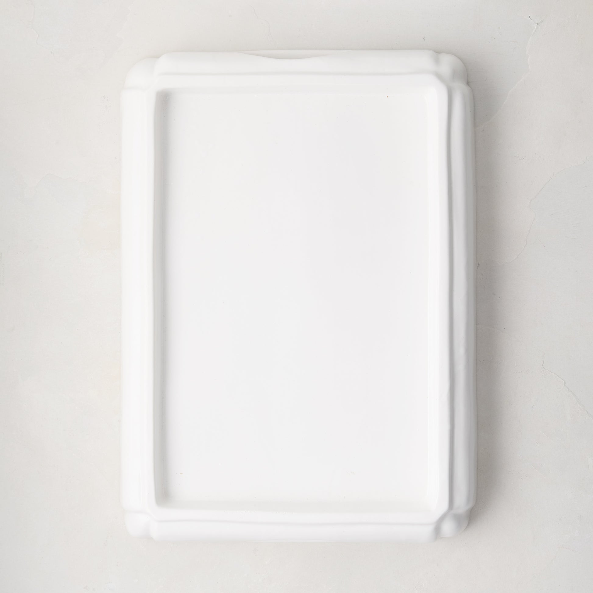White ceramic handled cutting board base, 18"L x 13"W.