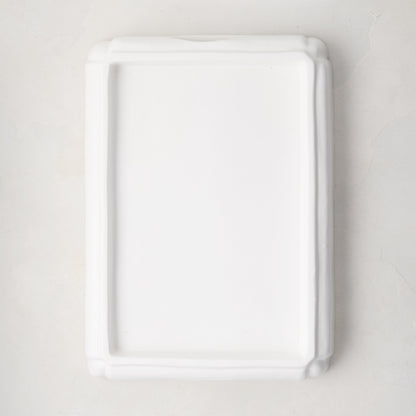White ceramic handled cutting board base, 18"L x 13"W.