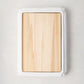 White ceramic handled cutting board with light oak wood surface, 18"L x 13"W.