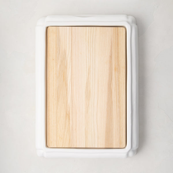 White ceramic handled cutting board with light oak wood surface, 18"L x 13"W.