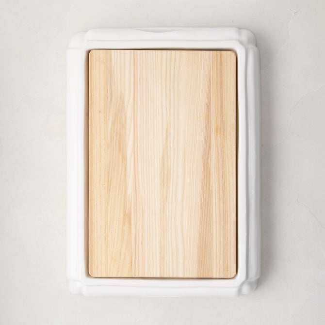 White ceramic handled cutting board with light oak wood surface, 18"L x 13"W.