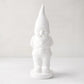 White ceramic holiday gnome with a tall, pointed hat and creamy white glaze.