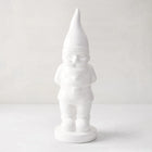 White ceramic holiday gnome with a tall, pointed hat and creamy white glaze.