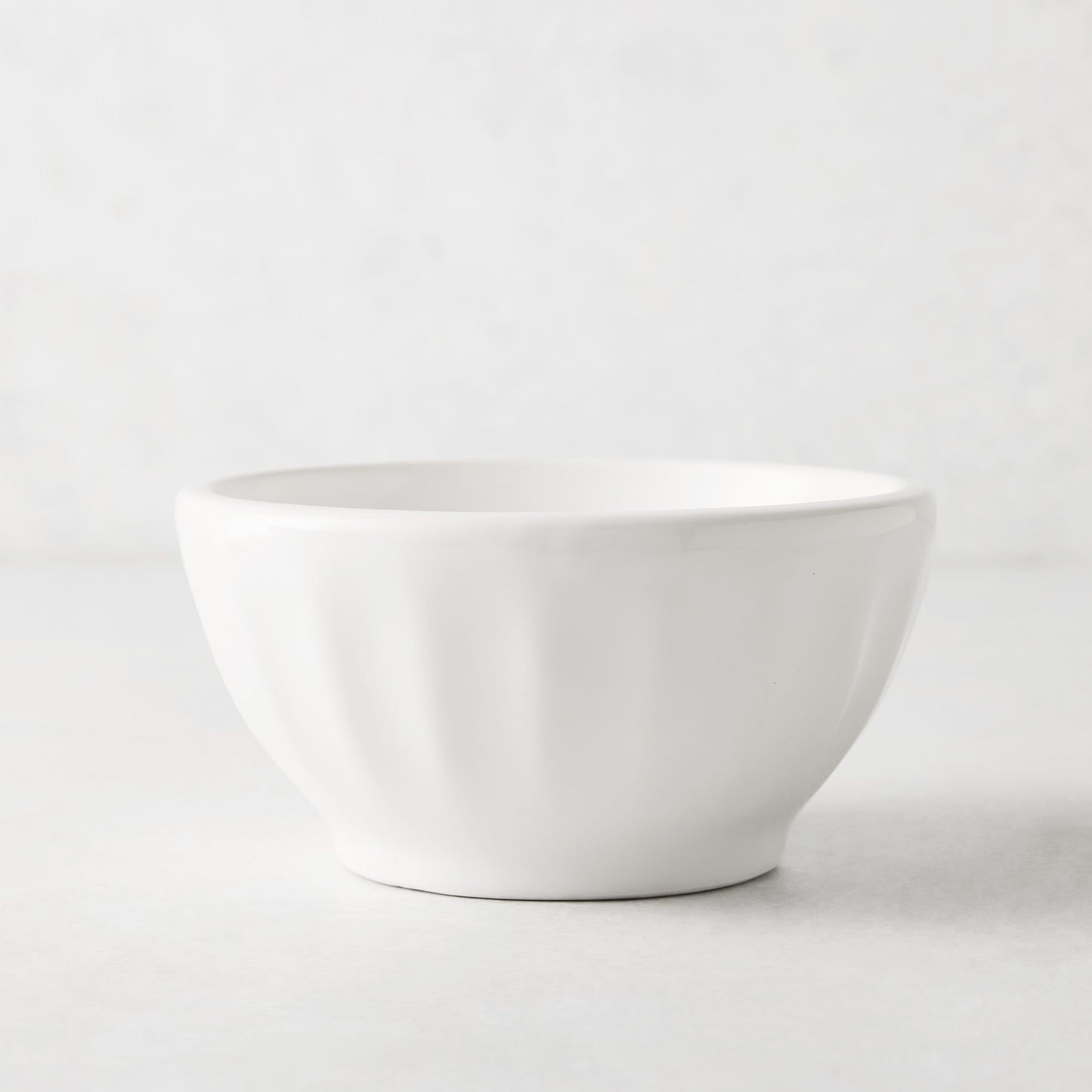 White ceramic latte bowl, 5.5" diameter, with subtle fluted sides.