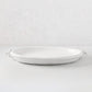 White ceramic oval platter with faux strap ring handles, 22.5"L.