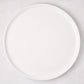 White ceramic round pizza serving platter, 12.6-inch diameter, with a subtle raised edge.