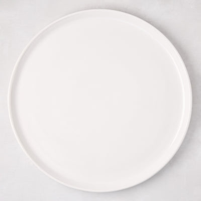 White ceramic round pizza serving platter, 12.6-inch diameter, with a subtle raised edge.
