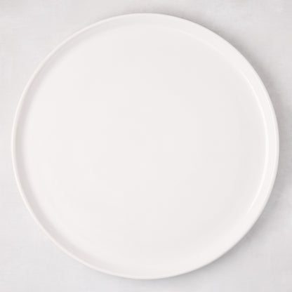 White ceramic round pizza serving platter, 12.6-inch diameter, with a subtle raised edge.
