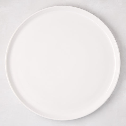 White ceramic round pizza serving platter, 12.6-inch diameter, with a subtle raised edge.