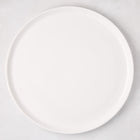 White ceramic round pizza serving platter, 12.6-inch diameter, with a subtle raised edge.