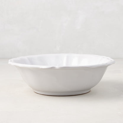 Handmade white ceramic bowl from the Deruta collection with a subtle scalloped edge, 7.4 inches in diameter.
