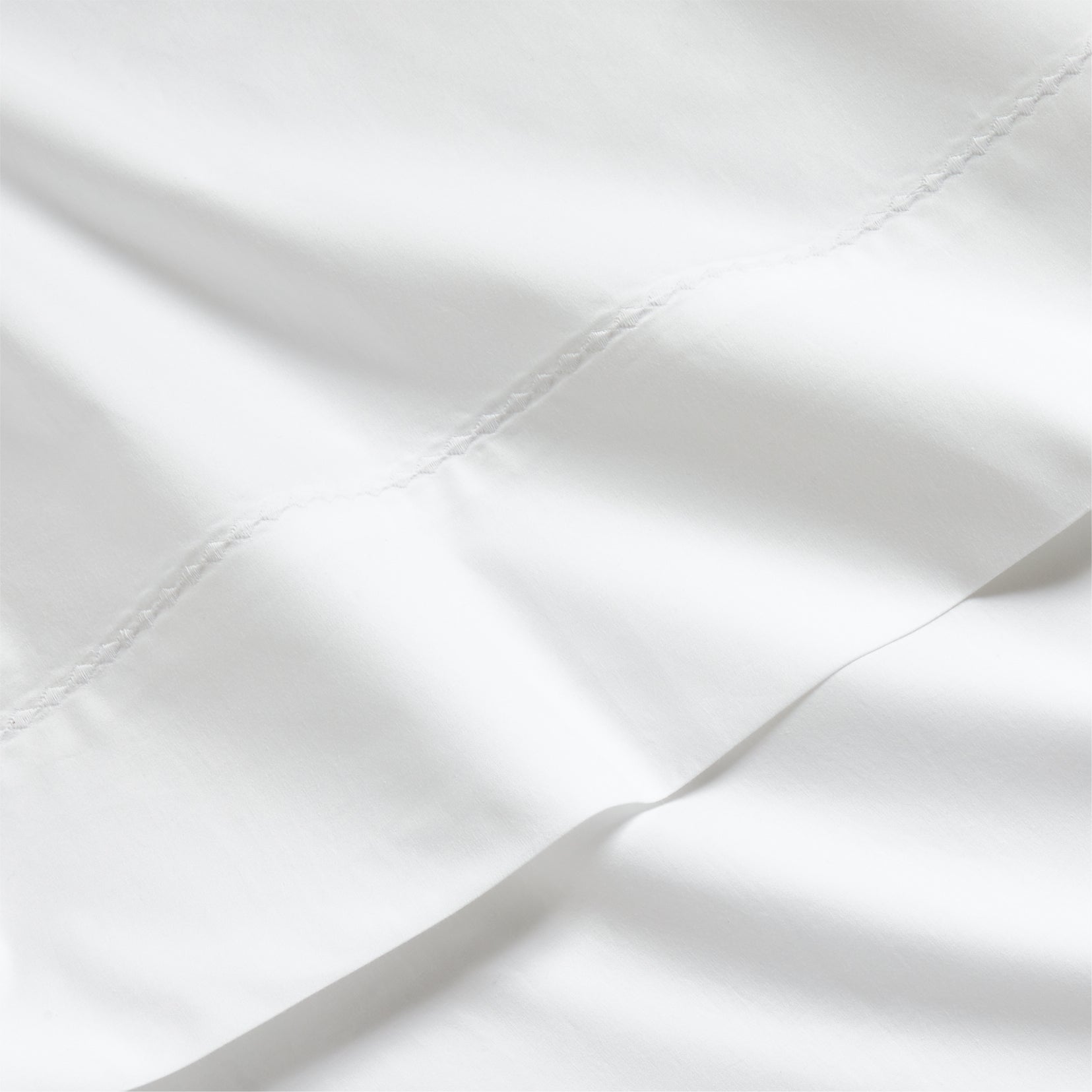 White Diamond Percale Sheet Set, crisp white extra-long staple cotton with subtle diamond embroidery.