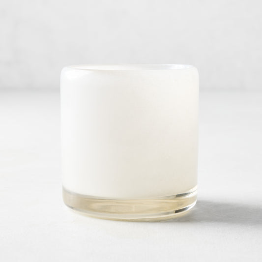 Small white glass votive candle holder, 2.75"Dia x 2.75"H, with a clear base.