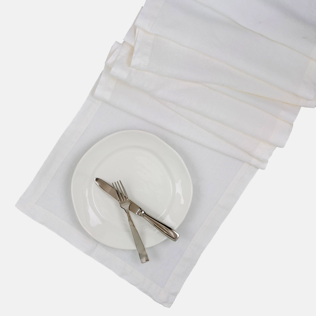 White HG Hand-dyed Linen Table Runner, 18"x108", with mitered corners and a plate setting.
