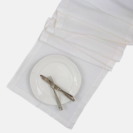 White HG Hand-dyed Linen Table Runner, 18"x108", with mitered corners and a plate setting.