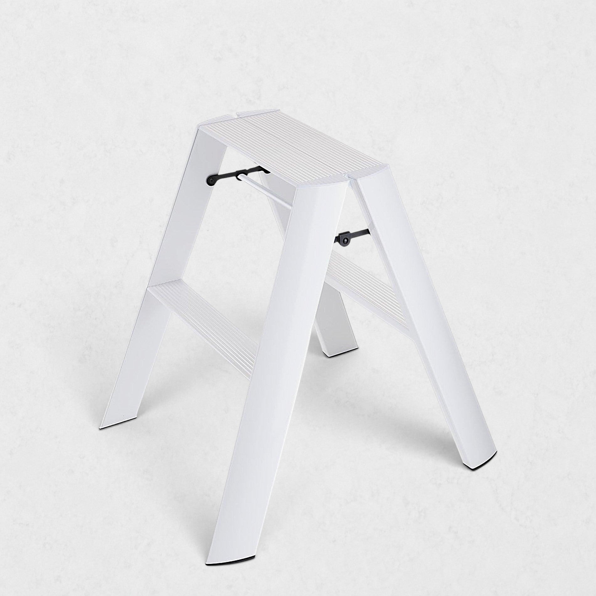 Hudson Grace white Hasegawa Lucano 2-step ladder with a minimalist aluminum and steel design and non-skid feet.