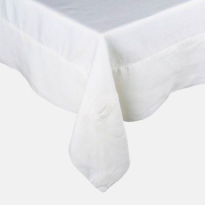 White HG Signature Hand-dyed Linen Tablecloth with generous border and mitered corner detailing.