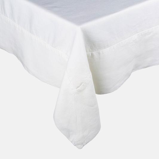 White HG Signature Hand-dyed Linen Tablecloth with generous border and mitered corner detailing.