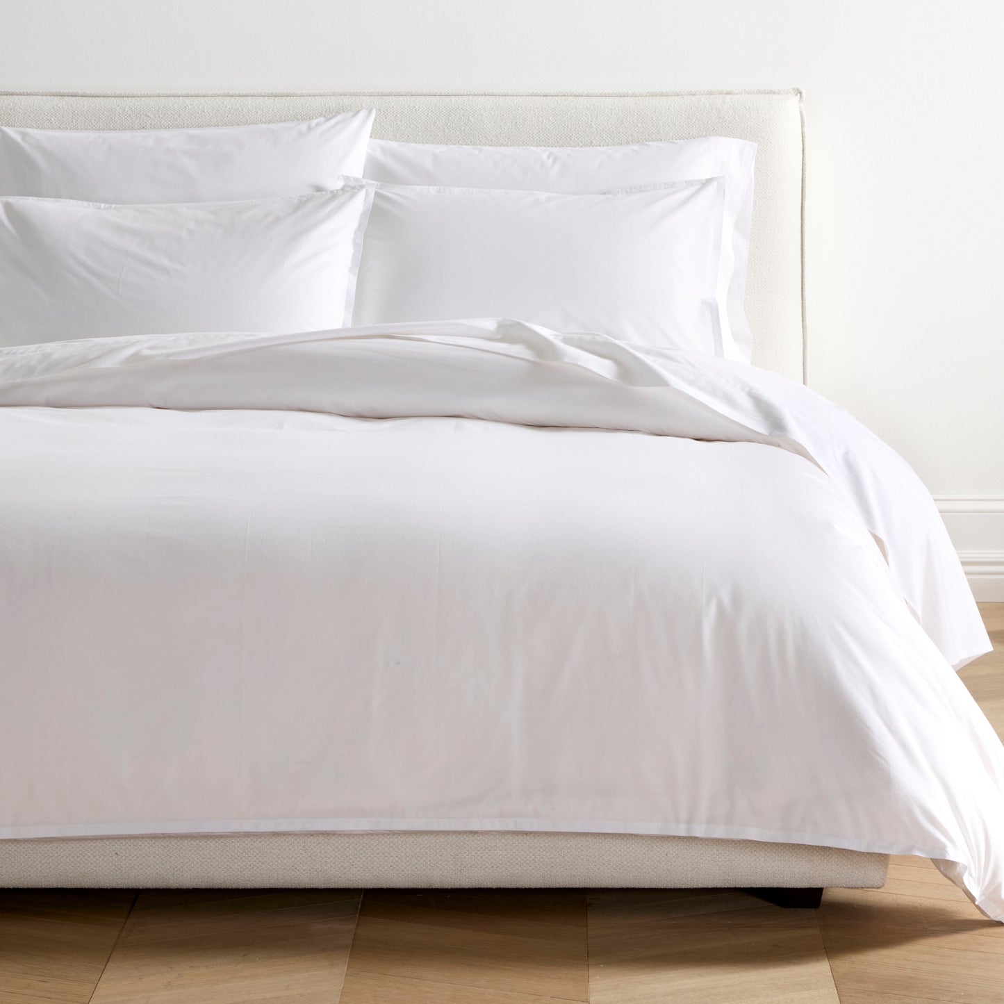 White Italian Percale Duvet Set with duvet cover and two shams on a bed.