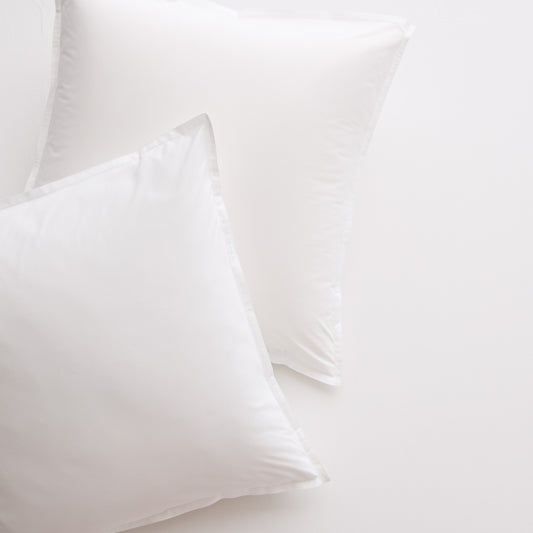 Two white Italian percale Euro shams, crisp cotton fabric with envelope closures, on a light background.