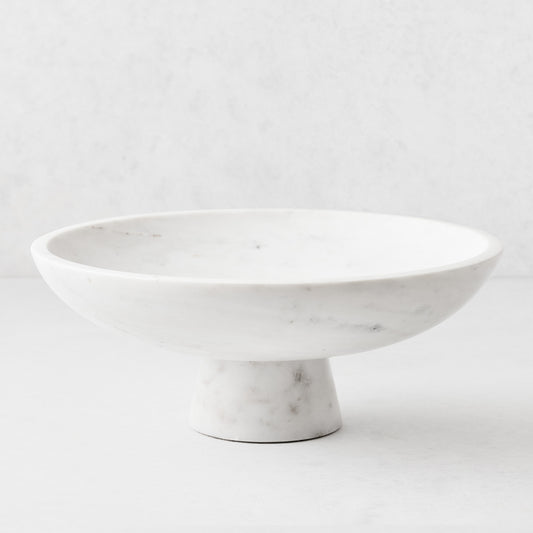 White marble footed serve bowl, 12"Dia x 4.75"H, with sleek curved edges and sturdy base.