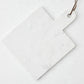 White marble square serve board with handle and brown leather strap.