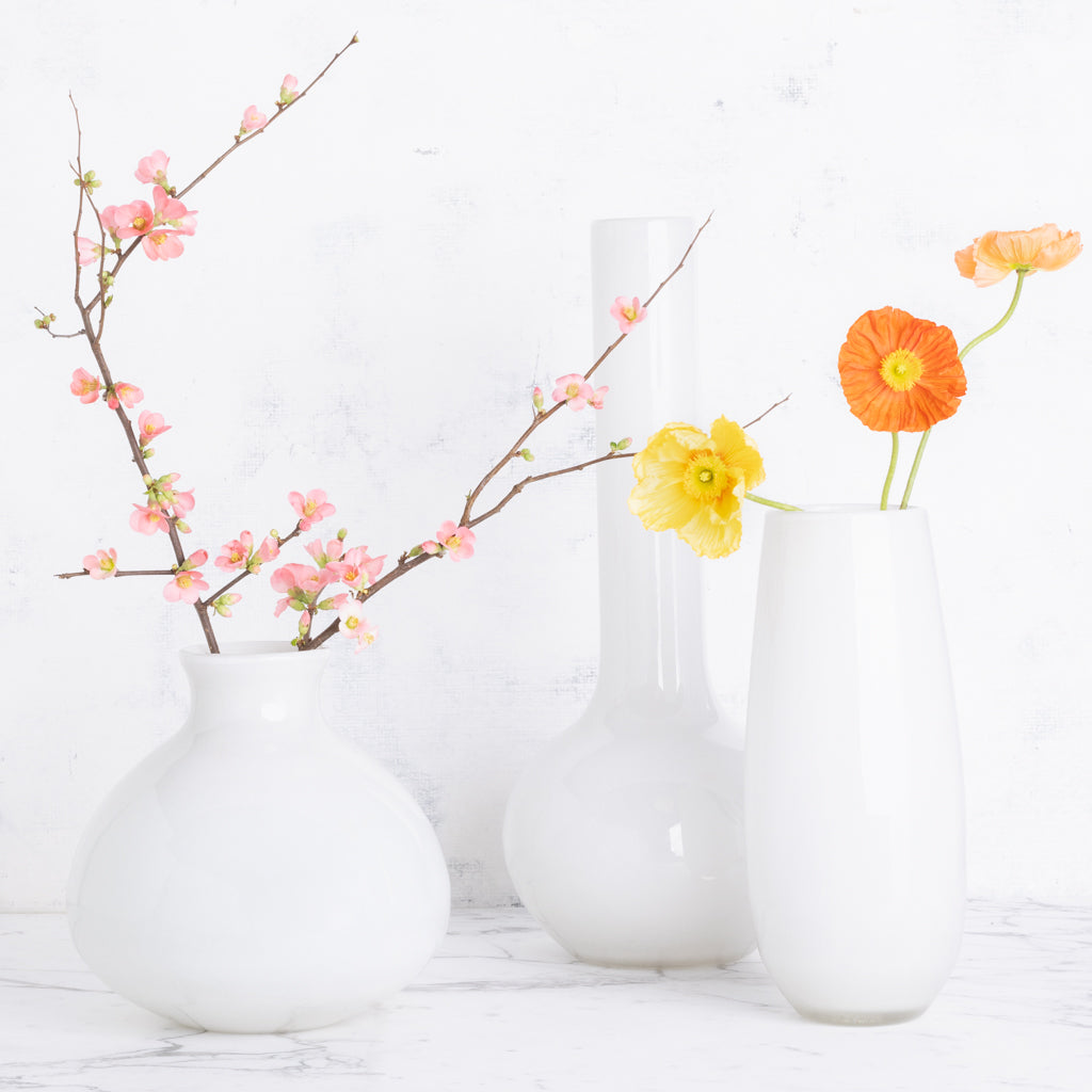 Oversized opaque White Margaux Vase, 14.5"H handblown glass, holding orange and yellow poppies.