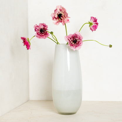 White Margaux Vase, 14.5"H handblown glass, with pink ranunculus flowers.