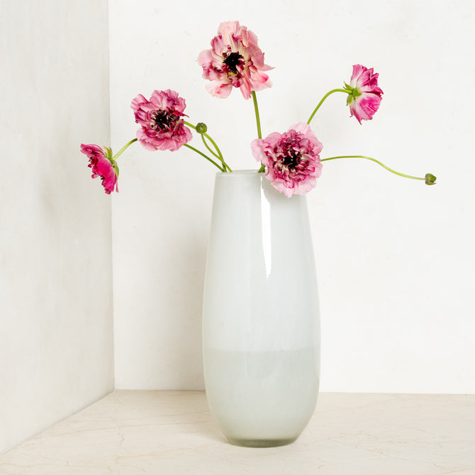 White Margaux Vase, 14.5"H handblown glass, with pink ranunculus flowers.