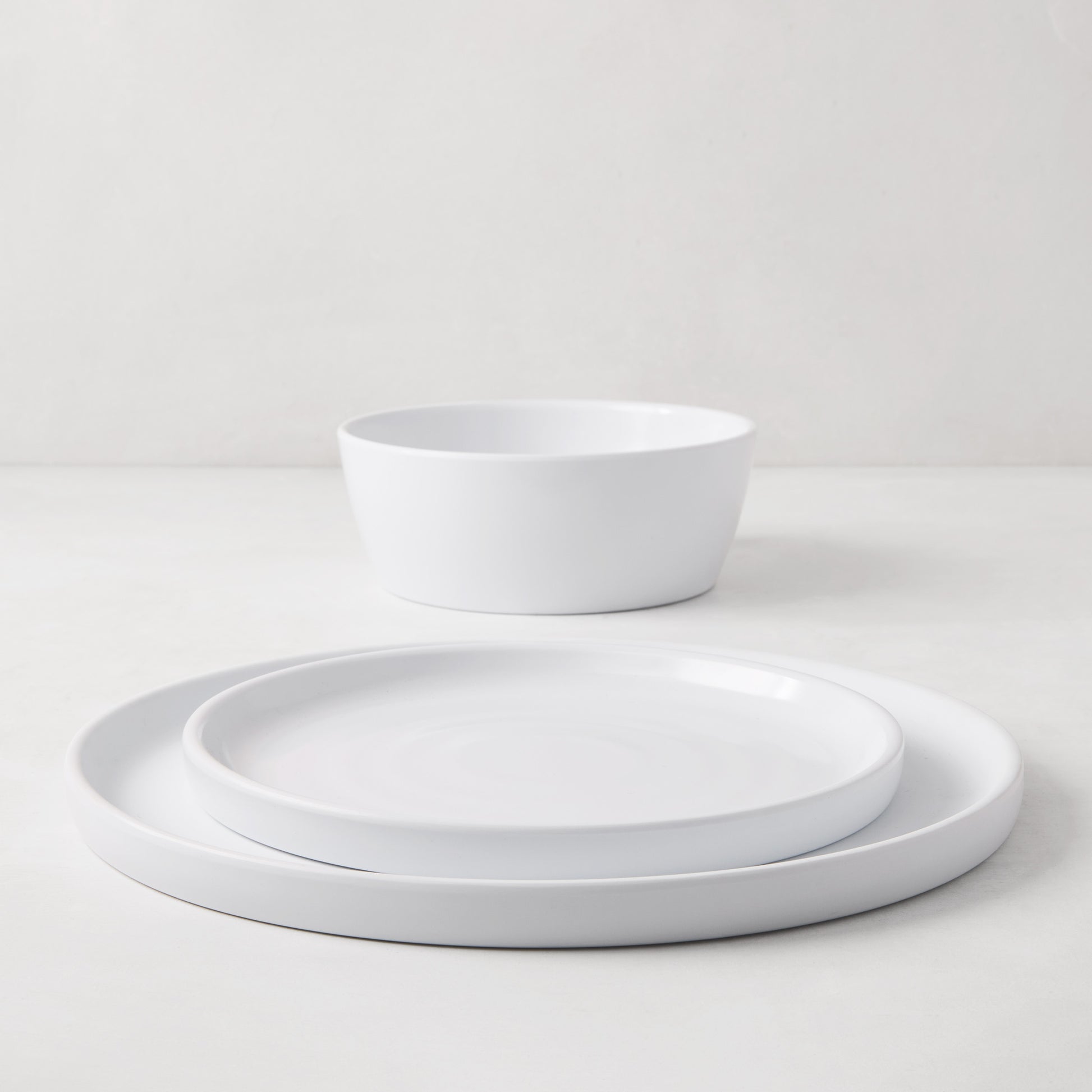 HG White Melamine Dinner Plate, salad plate, and bowl with modern lipped design.