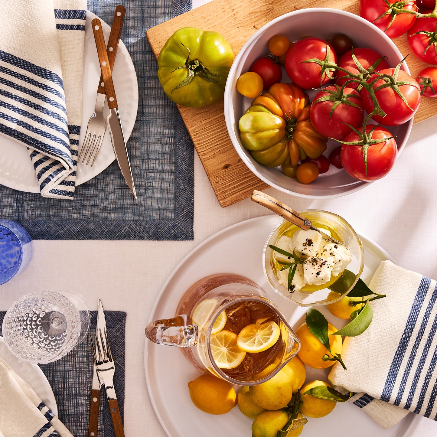 White melamine serve bowl with a modern lipped design, filled with colorful heirloom tomatoes.