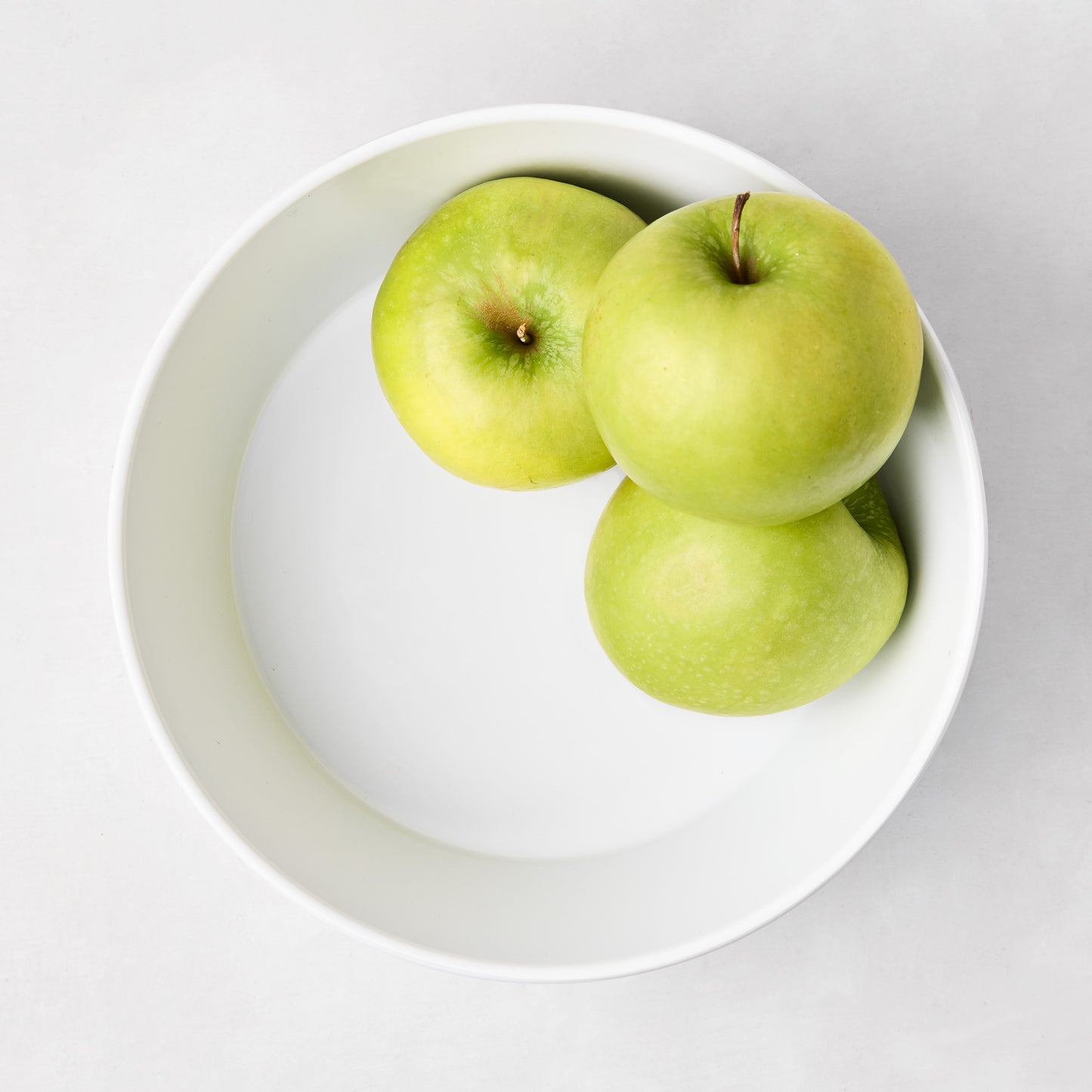 HG White Melamine Serve Bowl, 9"Dia, with three green apples.