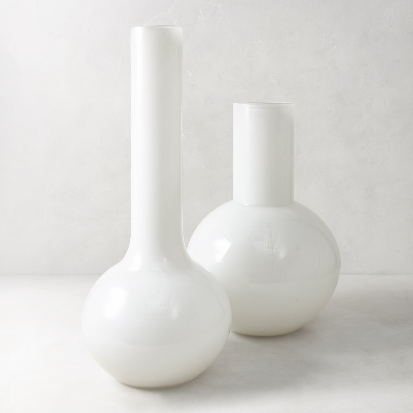 White oversized Grando glass vase, 18.8"H, with a round base and tall narrow neck.