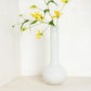 White oversized Raymond glass vase, handblown, with yellow flowers, 9.9”W x 23.6”H.