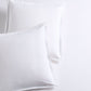Set of 2 white piped percale Euro shams made from organic cotton.