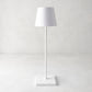 White Poldina indoor/outdoor rechargeable lamp with a sleek, minimalistic design and square base.