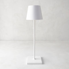White Poldina indoor/outdoor rechargeable lamp with a sleek, minimalistic design and square base.