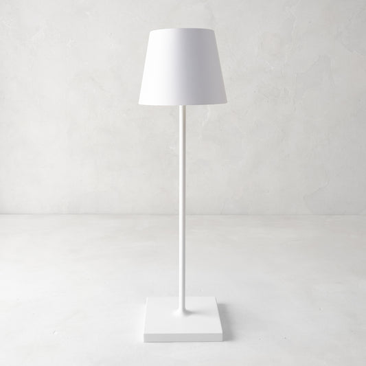 White Poldina indoor/outdoor rechargeable lamp with a sleek, minimalistic design and square base.
